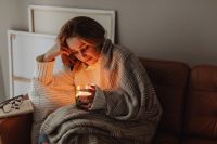Kaboompics - Cocooning on the Sofa with a Candle and Book