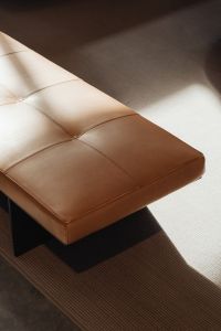 Kaboompics - Minimalist Brown Leather Bench on a Textured Rug