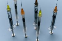 Kaboompics - Upright Medical Syringes on Blue Background