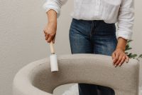 Kaboompics - Woman Cleaning Chair Upholstery with a Lint Roller
