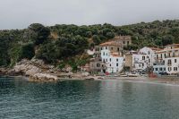Kaboompics - Rocky Cove and Marina di Puolo Waterfront Below a Tree-Covered Hill