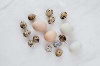 Kaboompics - Speckled Quail Eggs and White Chicken Eggs on Marble, Rustic Easter Food Styling