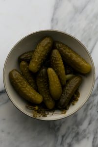 Kaboompics - Overhead Bowl of Assorted Pickles with Dill on Marble Background