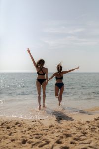 Kaboompics - Women Jumping into the Sea Together
