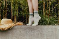 Kaboompics - White Striped Socks on Concrete Ledge with Straw Hat and Bamboo Background