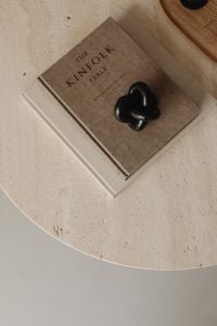 Kaboompics - Kinfolk Table Book with Black Knot Sculpture on Travertine Coffee Table