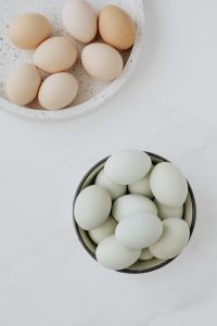 Kaboompics - Easter flat lay with green eggs on a white marble