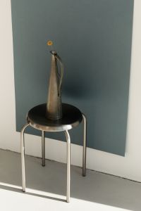 Kaboompics - Metal Sculpture and Stool in Minimalist Studio