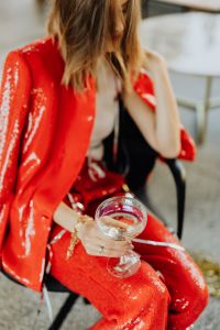 Kaboompics - Seated Champagne Lifestyle Portrait in Sparkling Red Trousers
