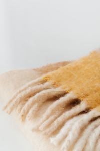 Kaboompics - Folded Cream and Tan Blanket Close-Up