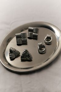 Kaboompics - Silver Statement Earrings on Round Metal Tray