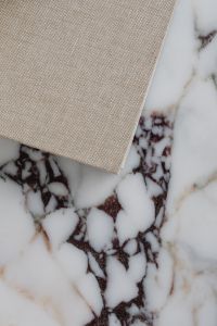 Kaboompics - Overhead View of Linen Book on Calacatta Viola Marble