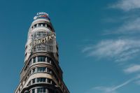 Kaboompics - Madrid Gran Vía Capitol and Schweppes Signs on a Curved Tower