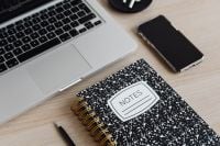 Kaboompics - Laptop, AirPods and Notes Notebook on Desk