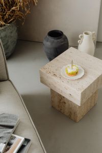 Kaboompics - Small Cake with a Candle on a Travertine Side Table