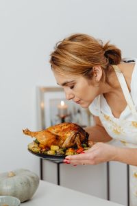 Kaboompics - Woman Presenting a Roast Turkey Platter for Thanksgiving