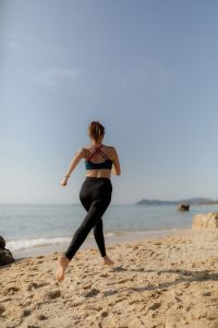 Kaboompics - Woman Jogging on a Rocky Beach