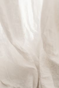 Kaboompics - Sheer White Fabric Background with Long Draped Folds and Airy Light