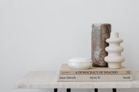 Kaboompics - White Sculptural Vase and Textured Vessel on Books