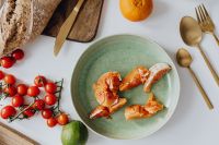Kaboompics - Orange and Cherry Tomatoes Beside a Bread Board