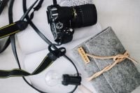 Kaboompics - Black camera with a grey wallet