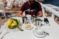 Kaboompics - Cups, silver jugs with coffee, Italian cookies and lemons on the table