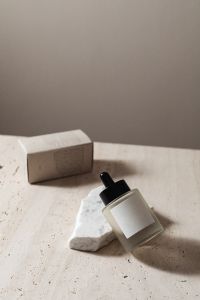 Kaboompics - Skincare Serum Bottle and Product Box Mockup on Travertine