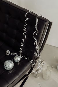 Kaboompics - Close-Up Black Leather Chair with Curled Party Ribbons and Disco Balls