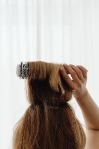 Kaboompics - Close-Up of a Round Brush Lifting Hair at the Crown