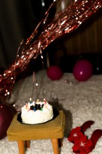 Kaboompics - Sparkling Rose Gold Party Tinsel over a Candlelit Birthday Cake