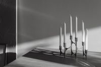 Kaboompics - Chrome Candelabra with White Candles and Long Shadows