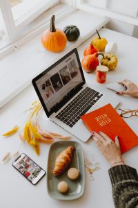 Female desk with orange notebook and pumpkins
