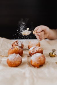 Kaboompics - Gold Mesh Sifter Dusting Homemade Paczki Doughnuts with Powdered Sugar