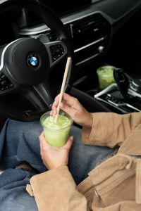 Kaboompics - Woman Stirring Matcha Latte With a Wooden Straw