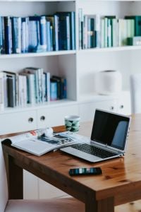 Kaboompics - Laptop, Coffee Mug, Smartphone and Open Magazine on a Wooden Desk