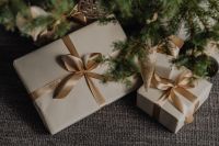Kaboompics - Neutral Christmas Presents Arranged on Textured Rug, Gift Wrapping Flat Lay
