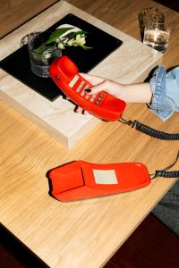 Kaboompics - Hand Holding Retro Phone Near Minimal Table Styling