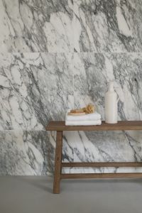 Kaboompics - Wooden Bench with Towels and Ceramic Vase Against Arabescato Wall