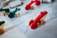 Kaboompics - Small wooden frogs with string