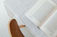 Kaboompics - Top View of an Open Book on White Linen Tablecloth