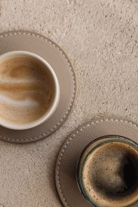 Kaboompics - Cropped Coffee Cups on a Textured Beige Background with Copy Space