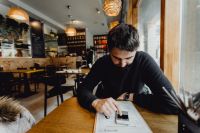 Kaboompics - Man using his mobile phone in the restaurant