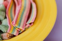 Kaboompics - Rainbow Sour Belt Candy Close-Up in Pink, Yellow and Green