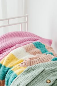 Kaboompics - Pastel Knitted Sweaters With Button Detail