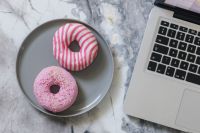 Kaboompics - Pink And Striped Donuts Beside Laptop