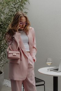 Kaboompics - Woman in a Pale Pink Suit with Laptop and Wine Glass