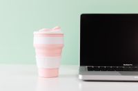 Kaboompics - Pink Reusable Silicone Cup on Mint Green Office Desk beside Laptop