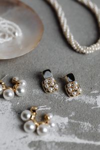 Kaboompics - Black Square Pearl Drop Earrings with Blurred Pearl Studs on Gray Concrete