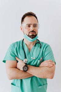 Kaboompics - Doctor with Clear Protective Glasses and Lowered Mask, Vertical Medical Professional Portrait