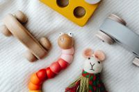 Kaboompics - Wooden Puzzle Cars and Bead Caterpillar with Handmade Mouse Doll